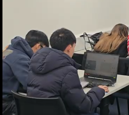 RoboSoc members programming together on laptops