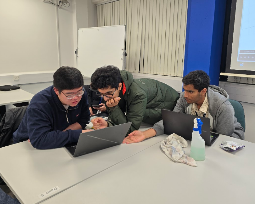 RoboSoc members working together at a technical workshop