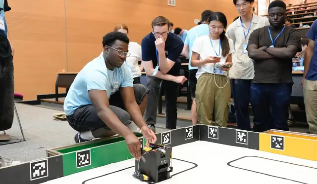 RoboSoc members testing a robot together at UniBots
