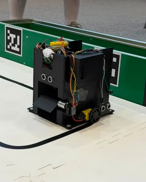 A student-built UniBots robot on the competition arena